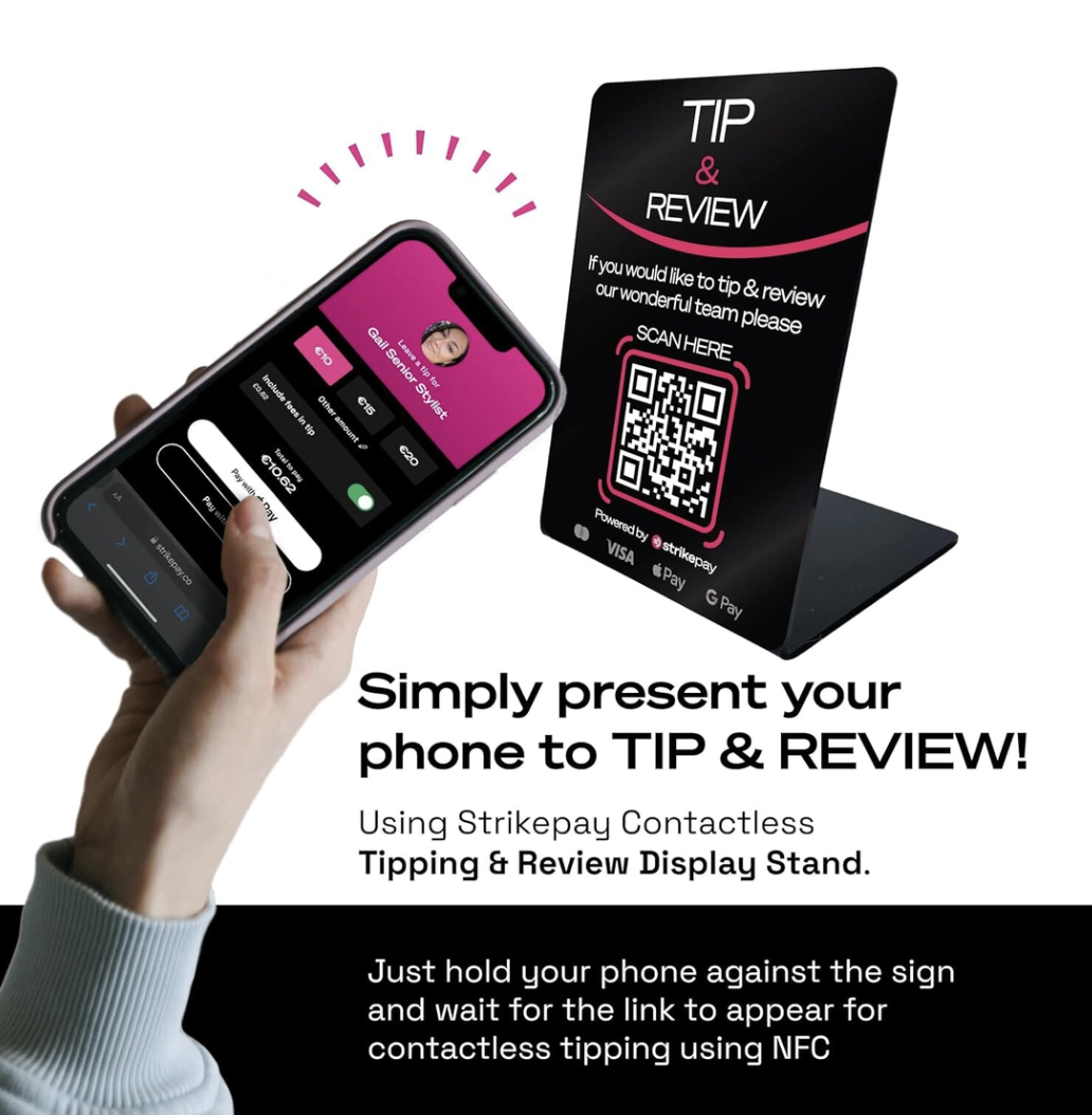 A hand holding a phone next to a striketip Tip & Review contactless tipping stand